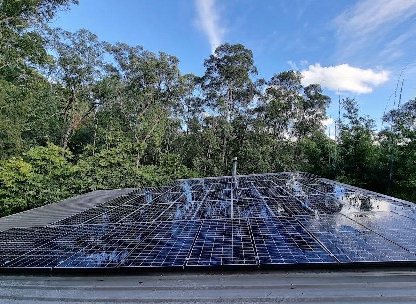 Solar panels mid-clean with water running off